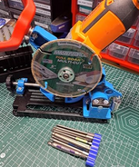 QuickMech angle grinder stand mounted with cordless angle grinder and 5 inch Masterforce diamond multi-cut blade ready to cut on a workshop bench with organized parts bins in background